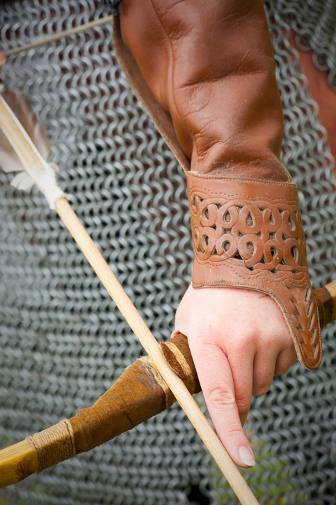 An archer in chainmail with bow drawn.